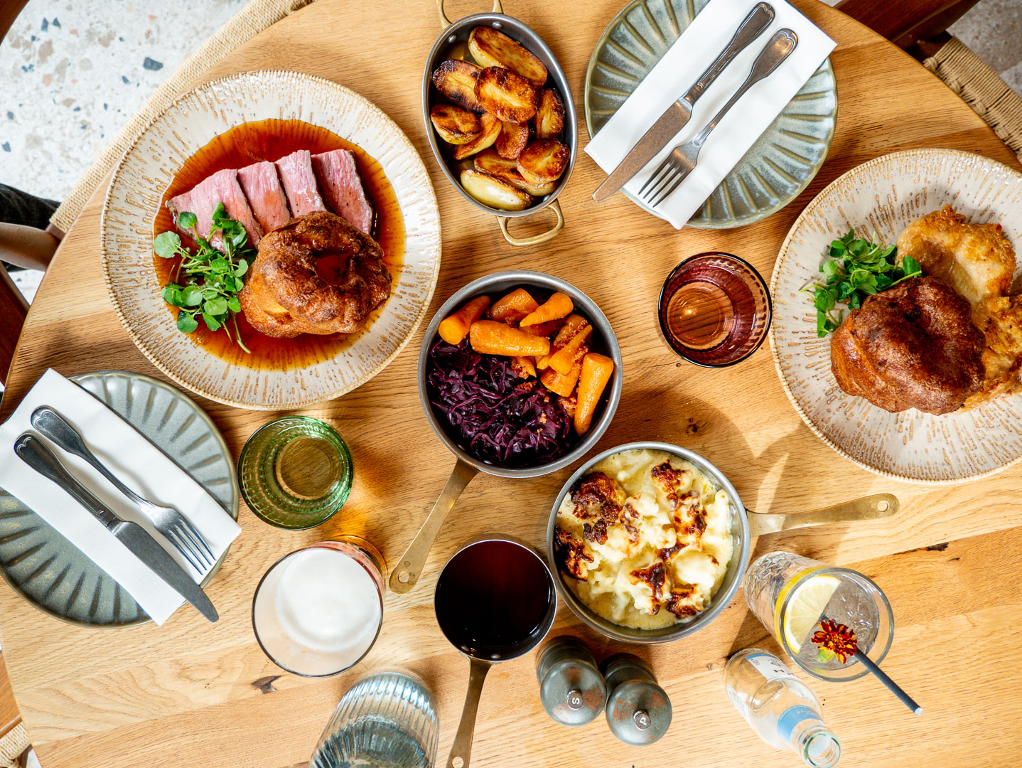 Top down view of Sunday Roast lunch at Old Harry Rocks Bar & Restaurant in Bournemouth. Roast Beef, Roast Chicken, Yorkshire Pudding, Carrots, Red Cabbage, Roast Potatoes, Cauliflower Cheese.